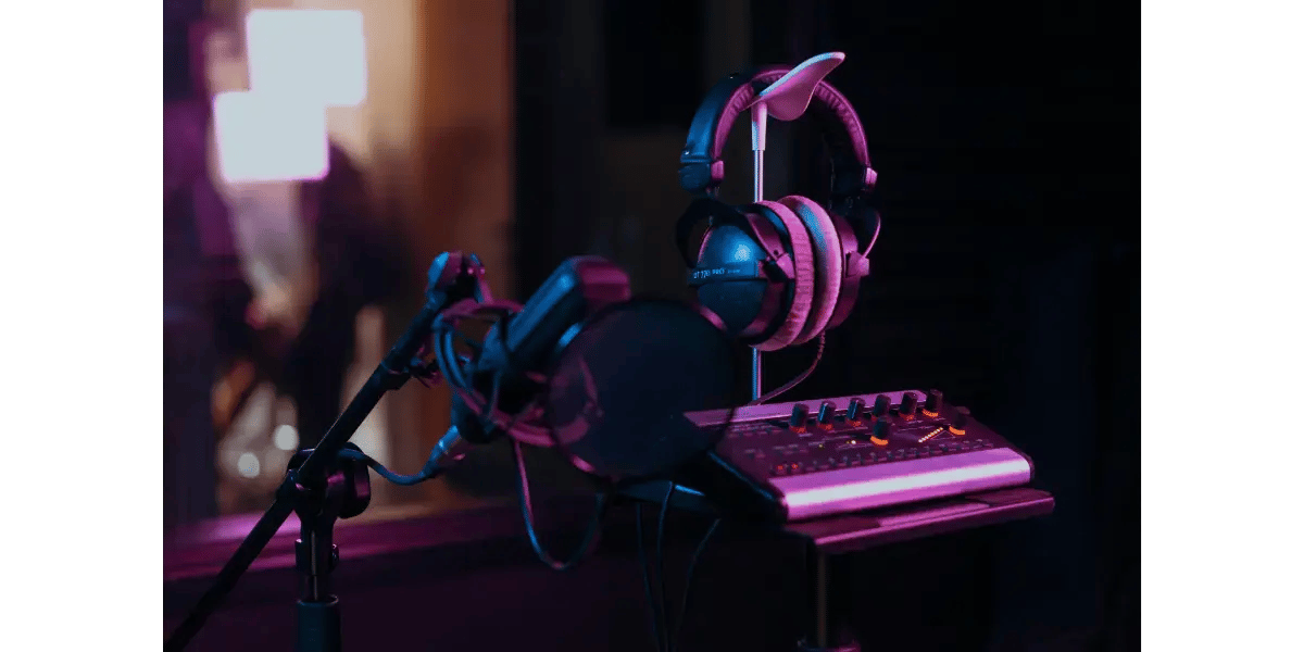 Neon-lit home music studio setup with microphone and headphones for contemporary commercial music singers