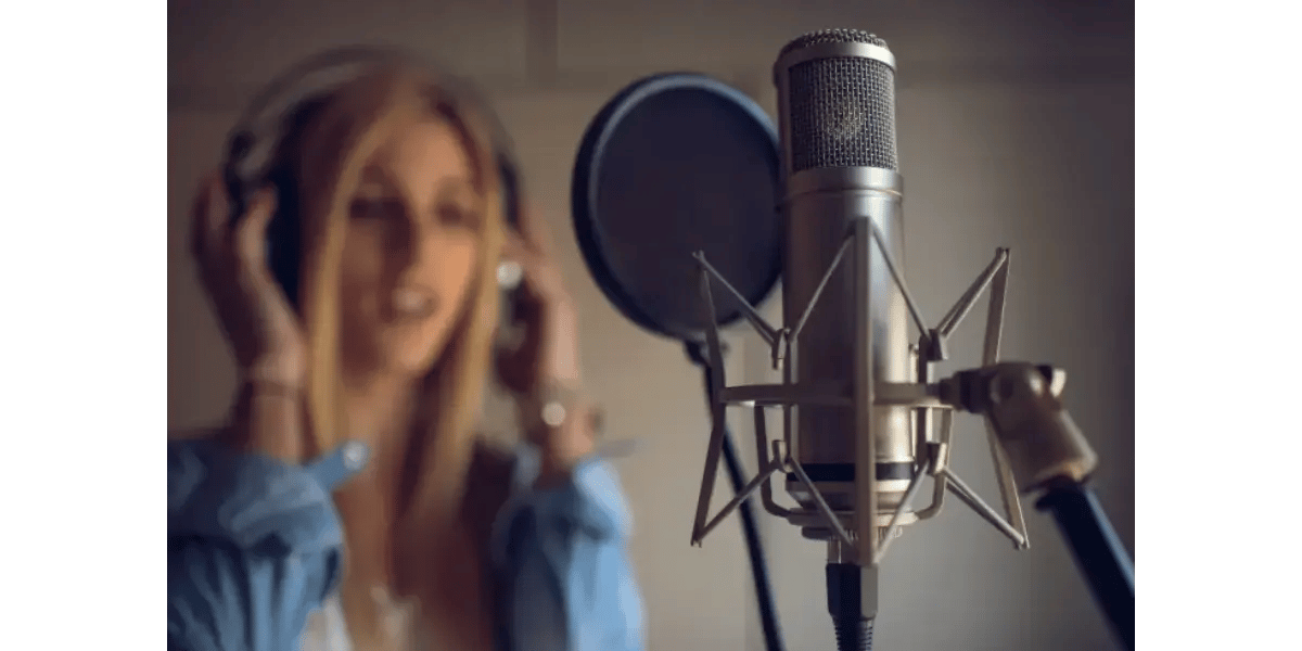 A female singer practicing vocal exercises and the major scale into a studio microphone.