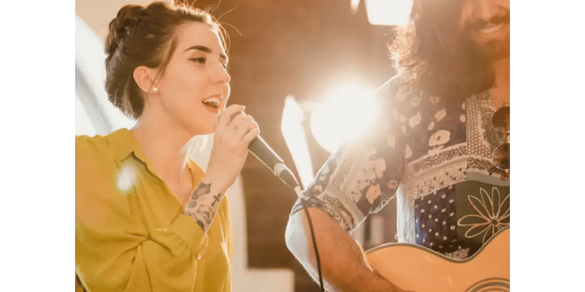 A singer feeling the muscles in her neck, demonstrating vocal anatomy and body posture basics for singing lessons.