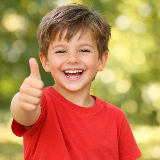 Happy kid thumbing up