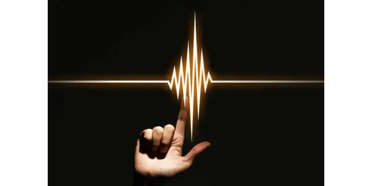 A close-up illustration of a hand carefully holding a pulsating sound wave visualized as a luminous sphere.