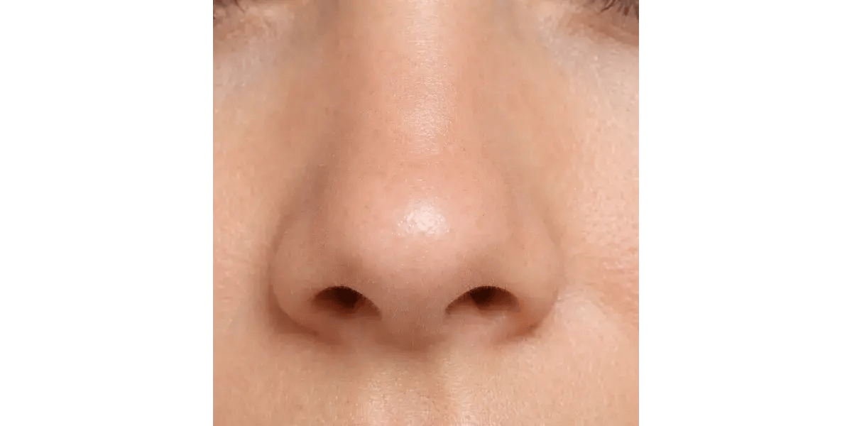 A close-up of a person's nose, representing nasal tone, airflow, and resonance in vocal training.