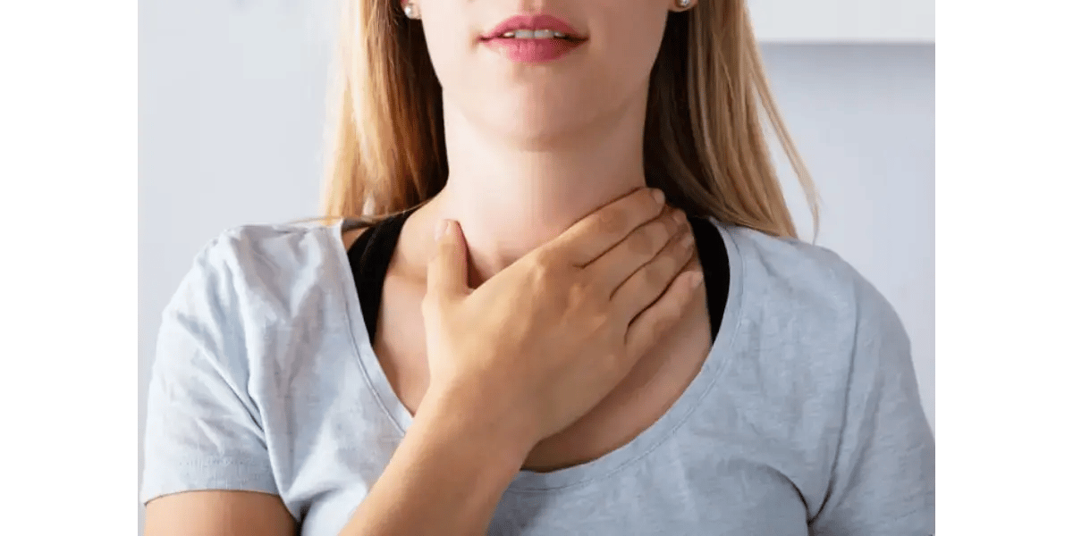 A singer placing her hands on her throat to feel vocal cord resonance and muscle tension.
