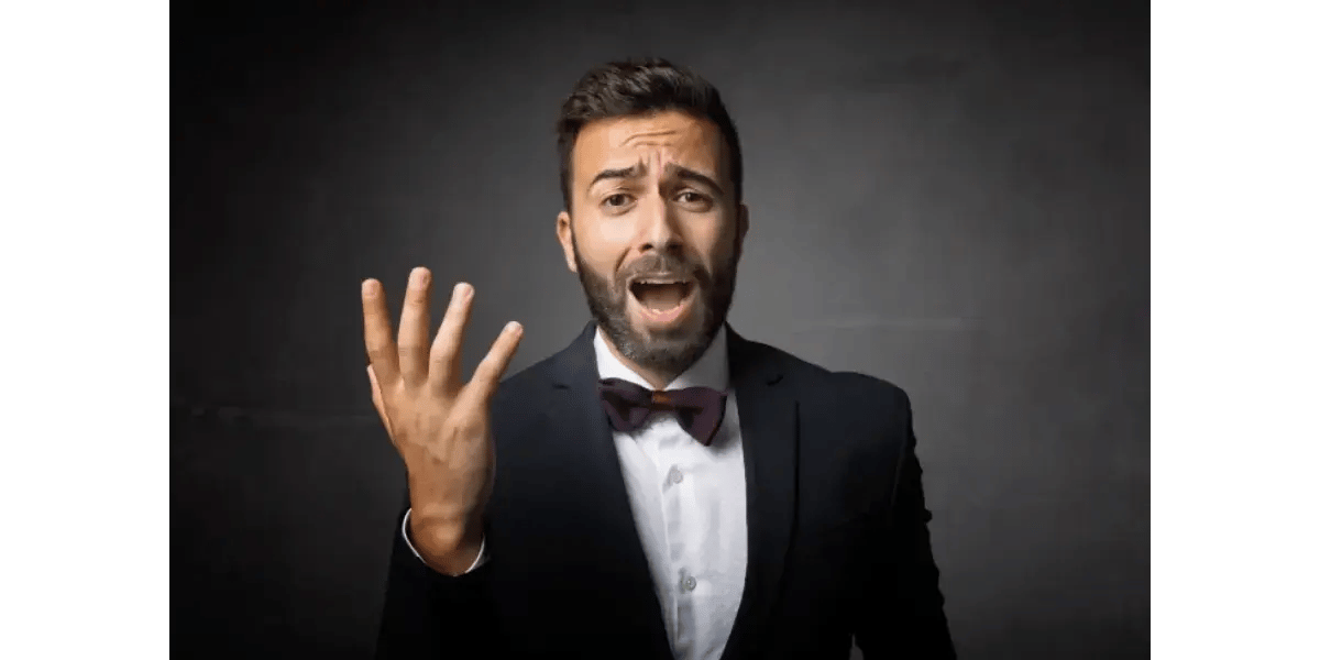 A male classical singer in a tuxedo, representing the common myth that head voice technique is only used in classical music.