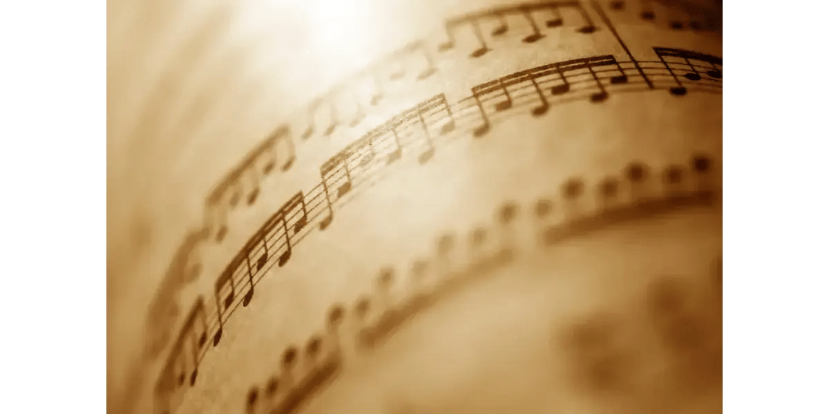 Rolled up vintage sheet music representing vocal training and music theory.