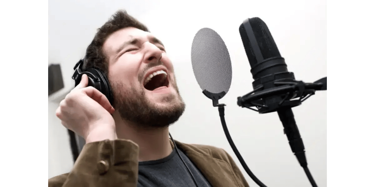A professional studio microphone used for recording vocals, representing vocal technique and vowel tuning.