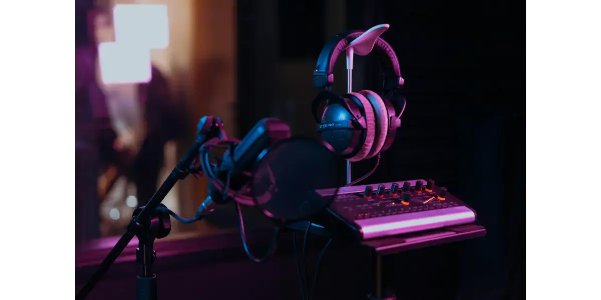 Neon-lit home music studio setup with microphone and headphones for contemporary commercial music singers