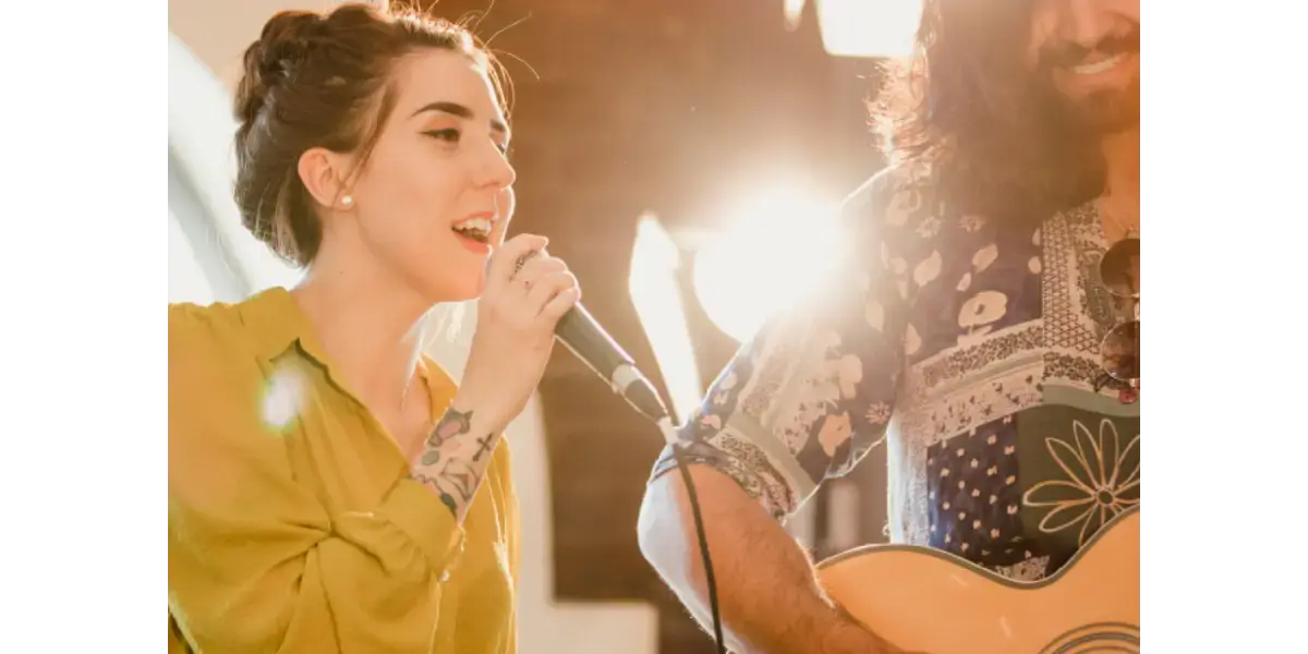A singer feeling the muscles in her neck, demonstrating vocal anatomy and body posture basics for singing lessons.