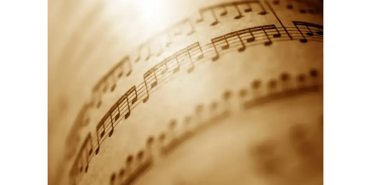 Rolled up vintage sheet music representing vocal training and music theory.