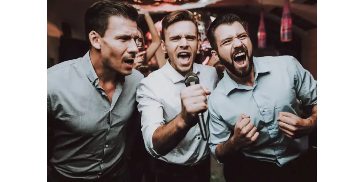 Three men singing passionately into microphones with their mouths wide open, representing vowel formation and vocal mechanics.