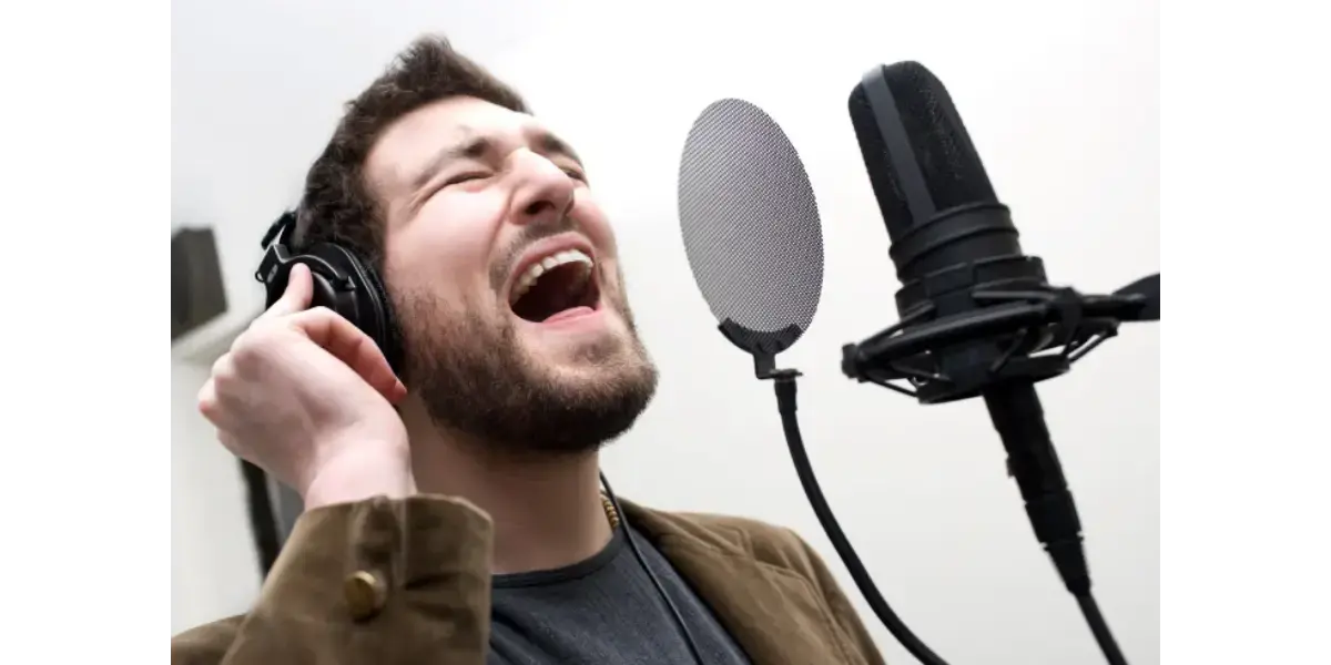 A professional studio microphone used for recording vocals, representing vocal technique and vowel tuning.